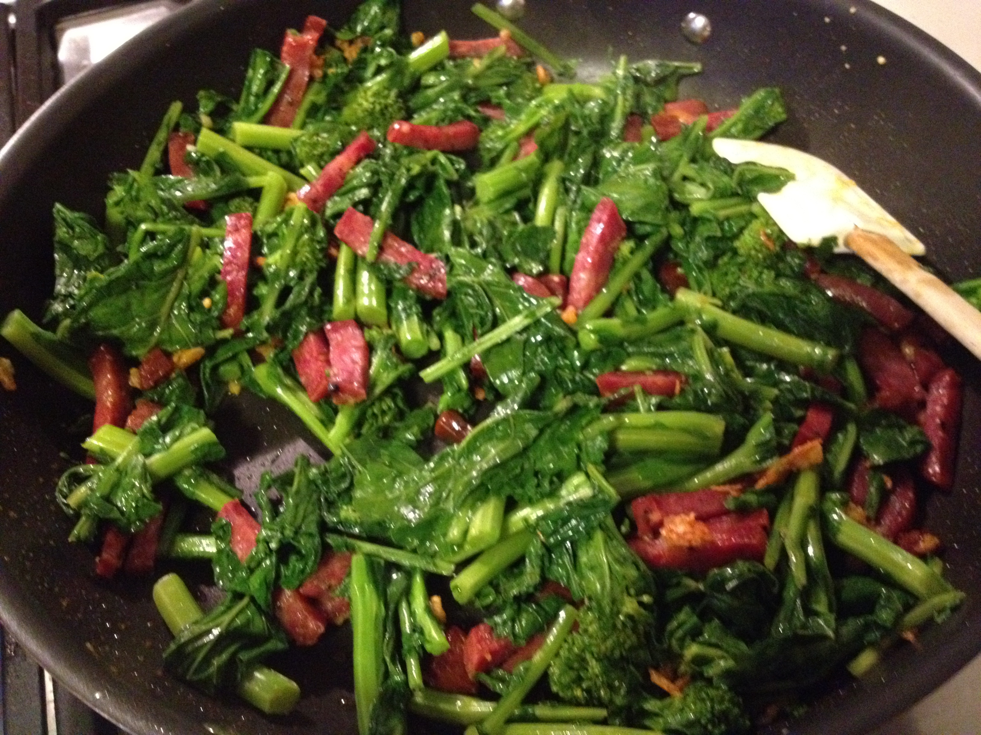 Broccoli rabe, sausage and garlic in a skillet.