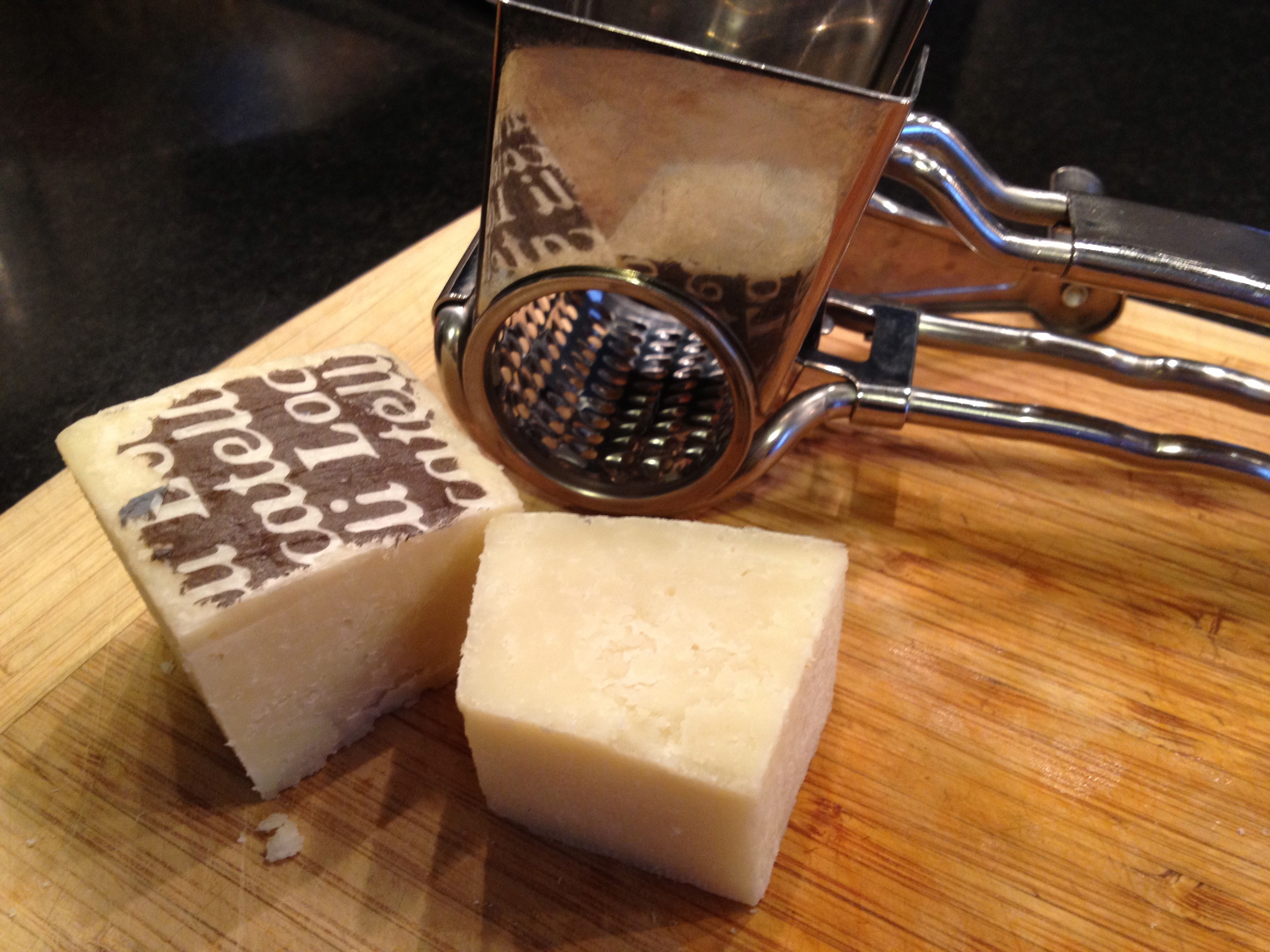 Romano cheese on a wooden cutting board.