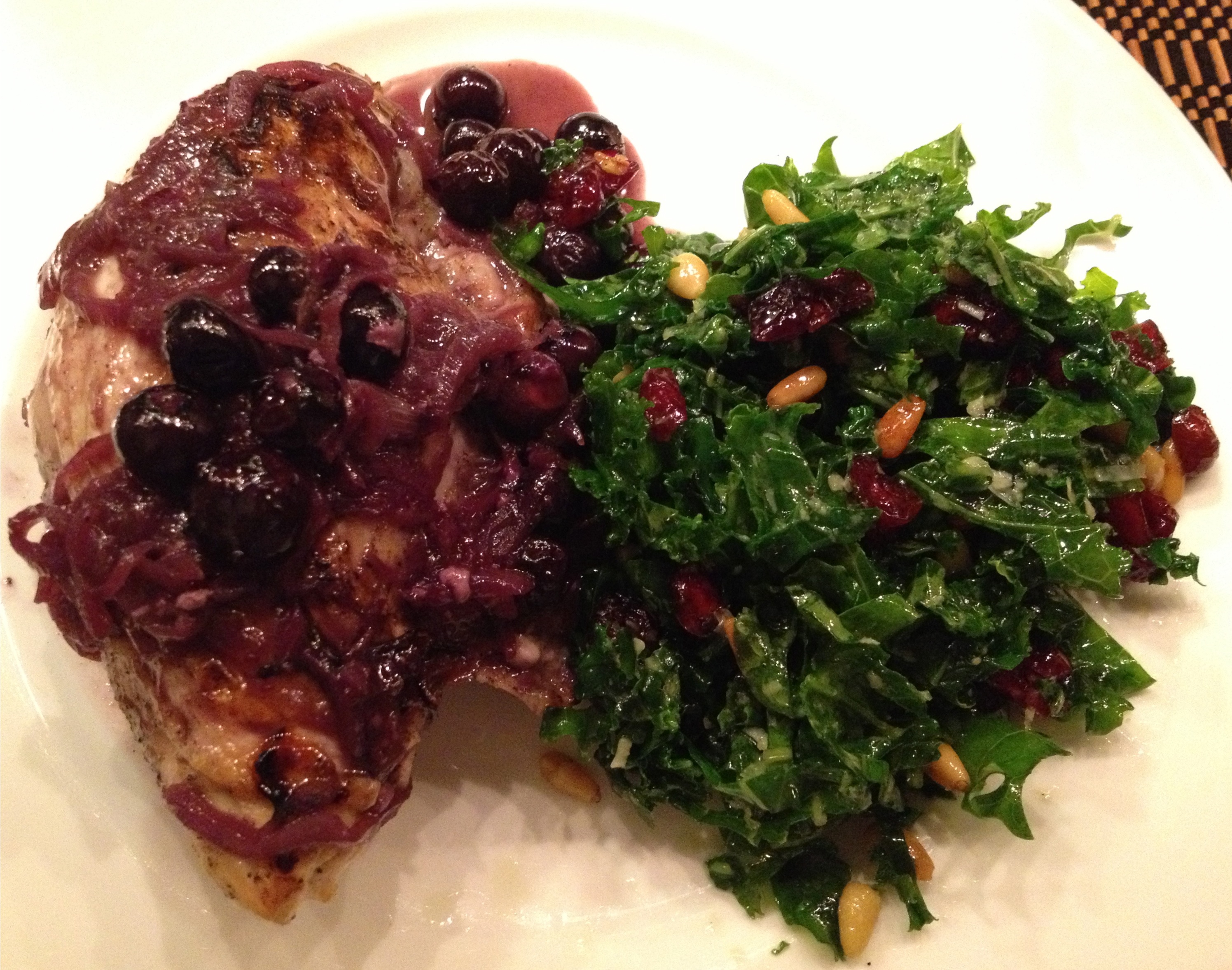 kale salad with sauteed chicken breast in white wine, shallots and blueberries