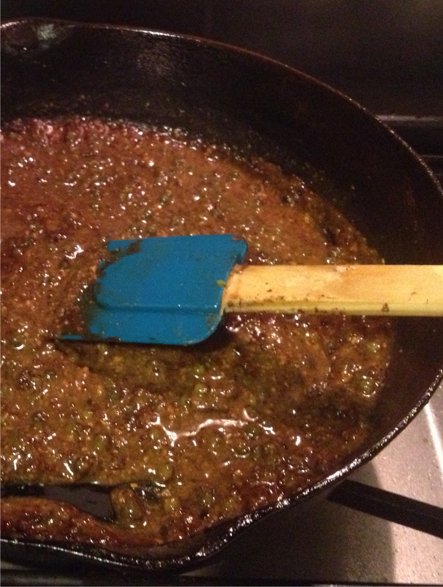 Green peppercorn gravy in a balck cast iron skillet - Tyler Florence recipe.