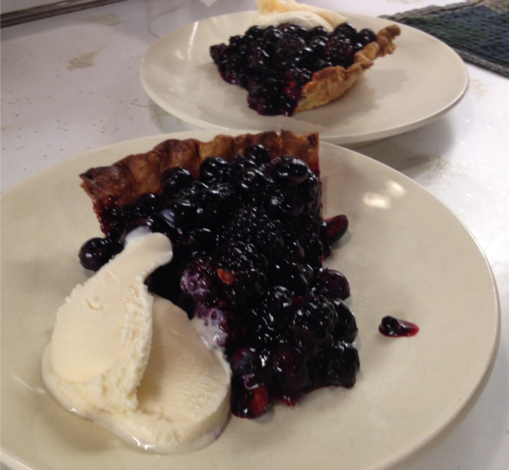 Best blueberry pie with blackberries, two pieces with vanilla ice cream.
