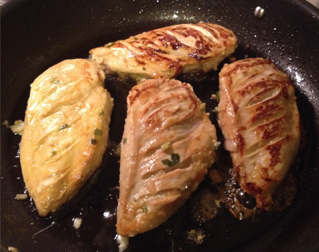 Tea and honey marinated chicken breasts browning in the pan 