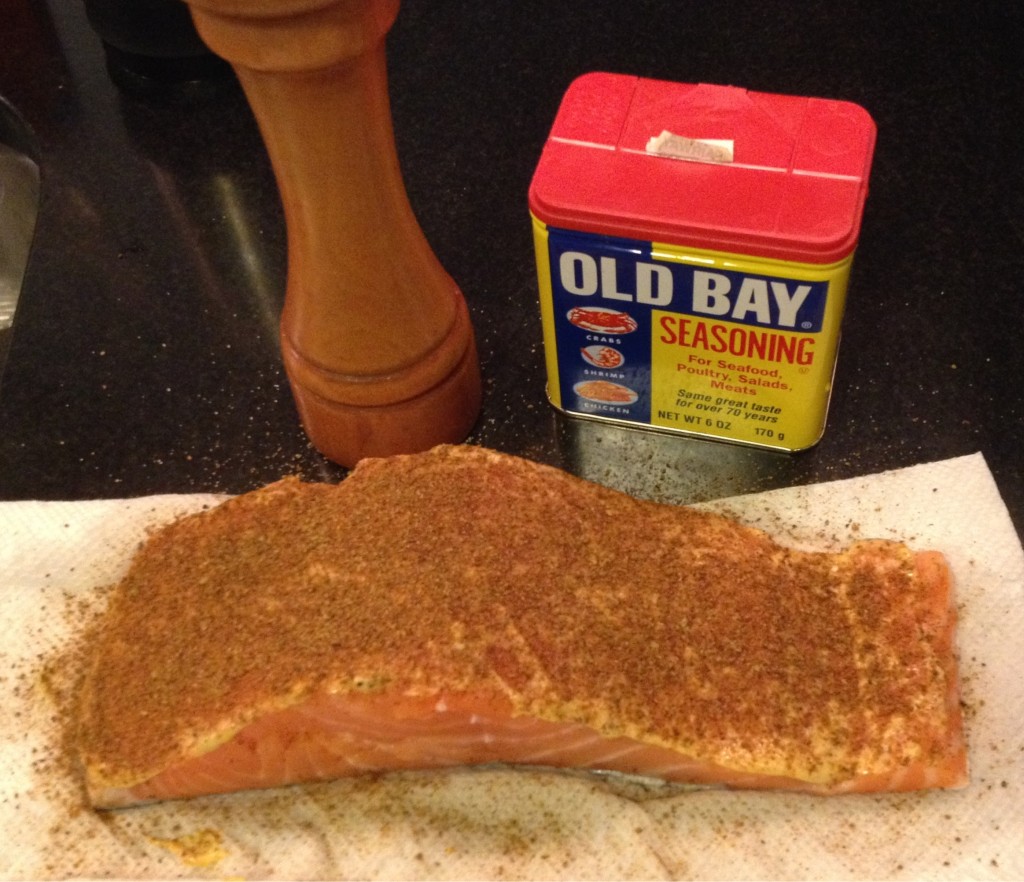 Salmon filet seasoned with Dijon mustard and Old Bay.