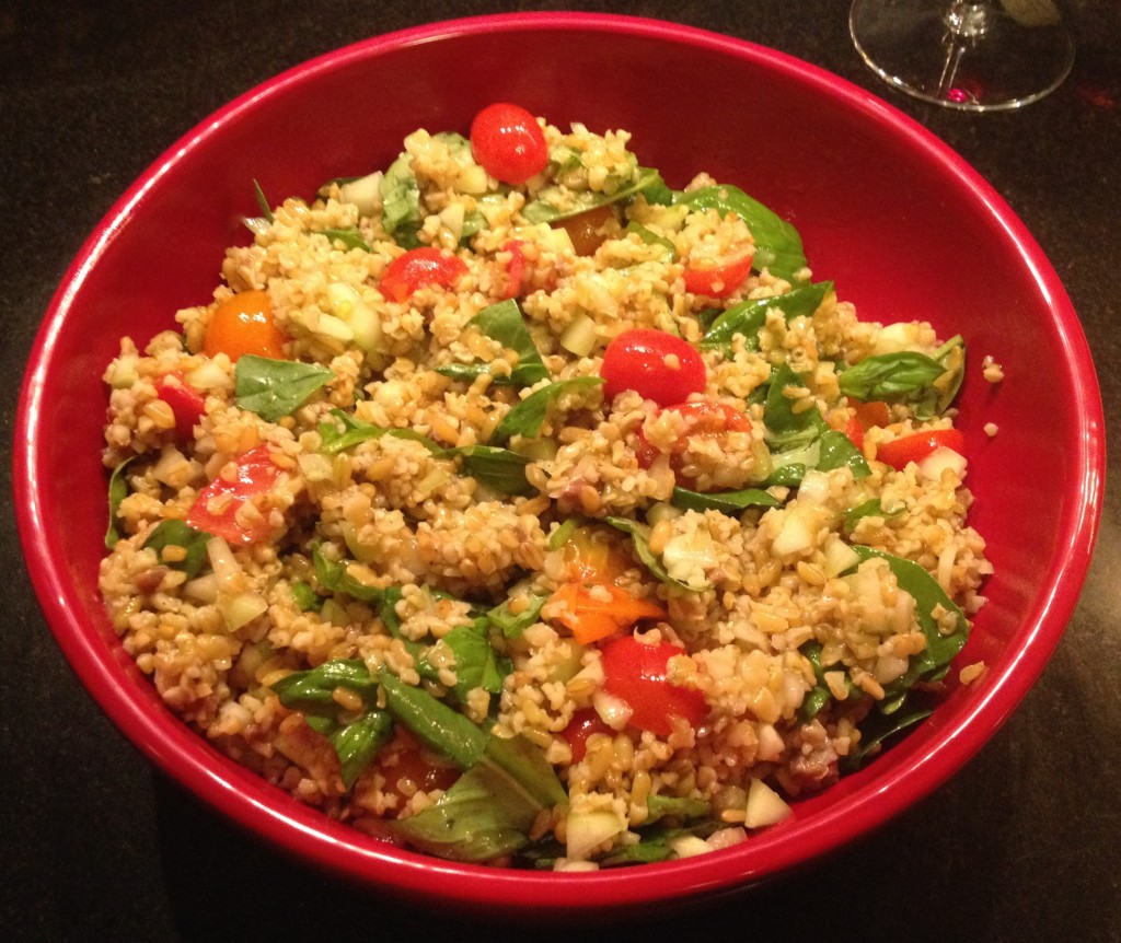 Freekeh salad in a red bowl.