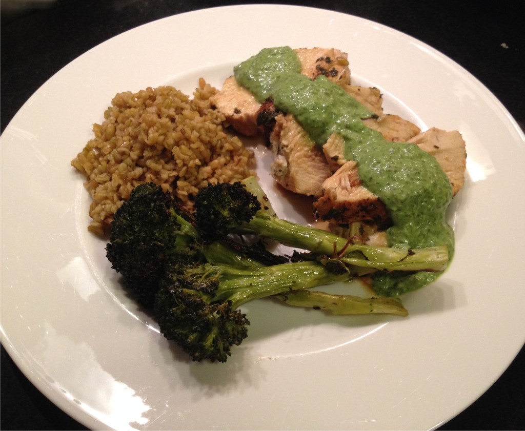Sorrel sauce on sliced chicken breasts with roasted broccoli and freekeh.