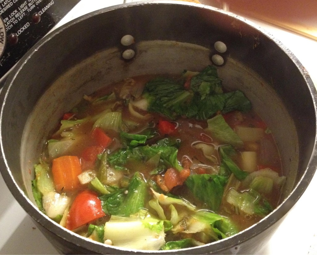 Vegetable soup in a pot with escarole.