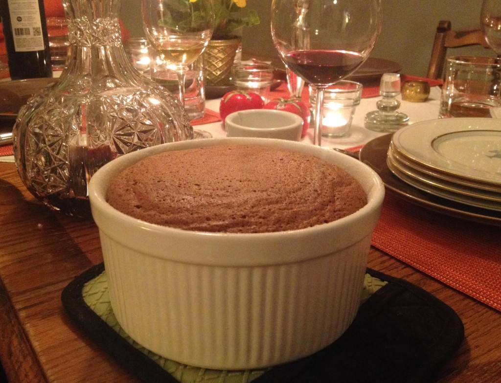 Chocolate souffle on a candlelit dining table