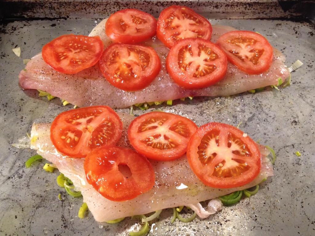 Preparing Lemon Sole raosted with leeks and tomatoes ready to go into the oven.