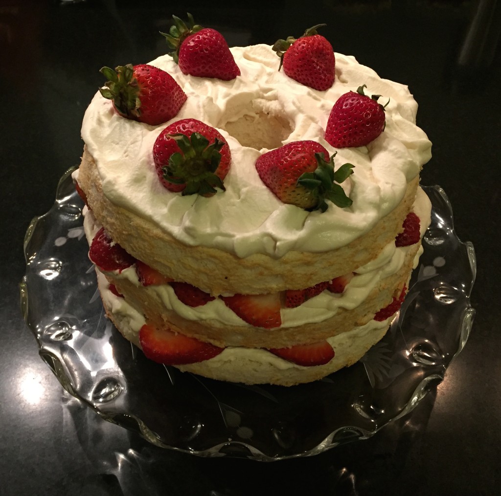 Angel food cake with whipped cream and strawberries.