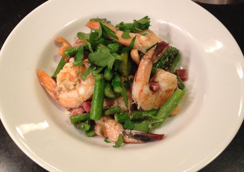 Shrimp and asparagus in a white bowl.