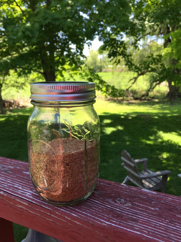 BBQ ribs spice rub in a jar  outside on a beautiful day.