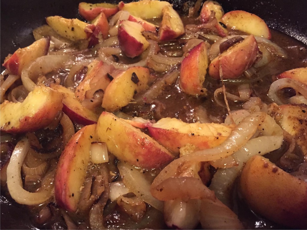 Pork and peaches - sauce in a skillet.