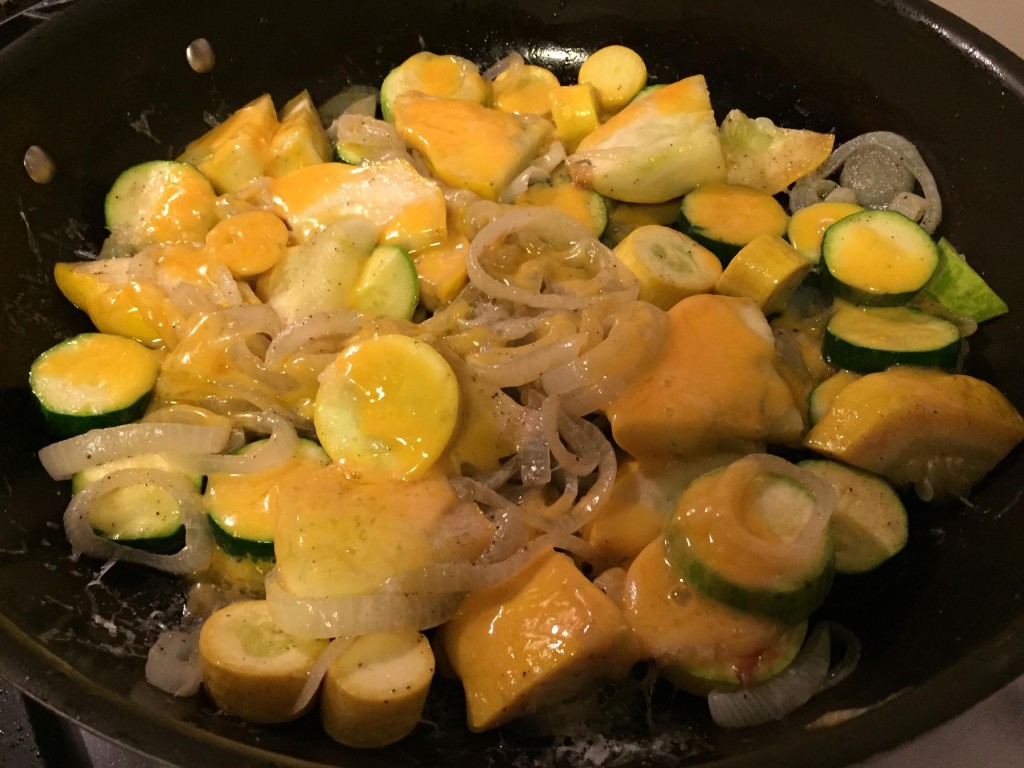 Easy cheesy sauteed squash finished in a skillet.