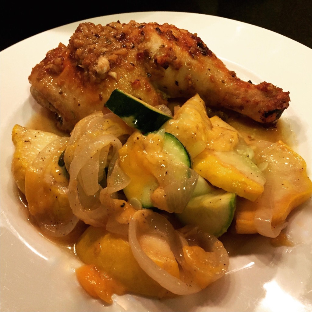 Easy cheesy sauteed squash with chicken on a plate.