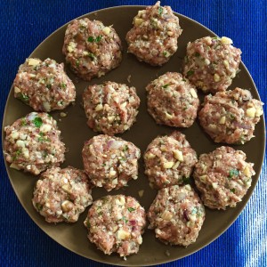 Delicious Sunday Morning Sausage Patties - raw patties on a brown plate.
