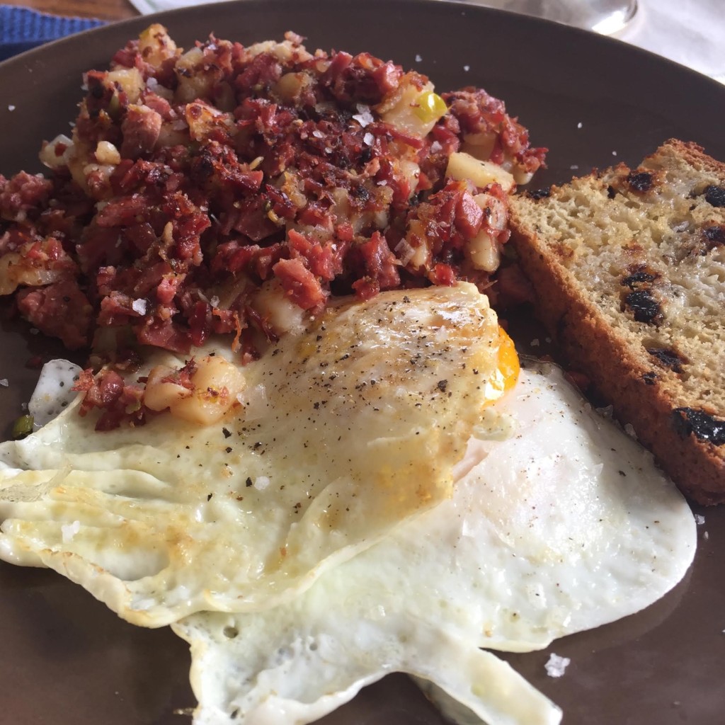 Corned beef hash and over easy eggs with toasted Irish soda bread.