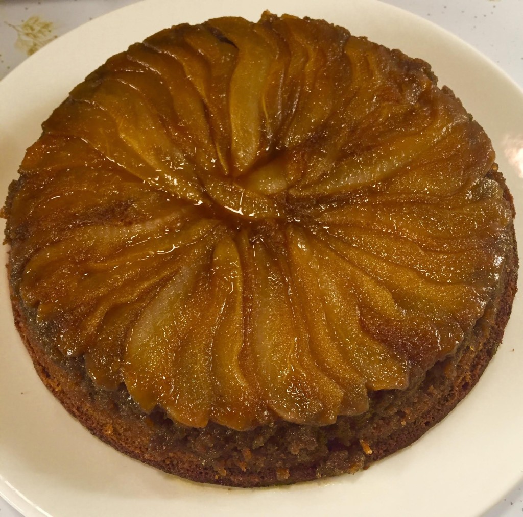 Pear and brown sugar upside down cake on a white platter.