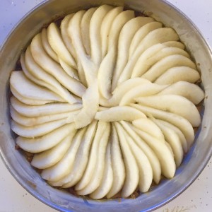 Pear and brown sugar upside down cake showing pears in pan.