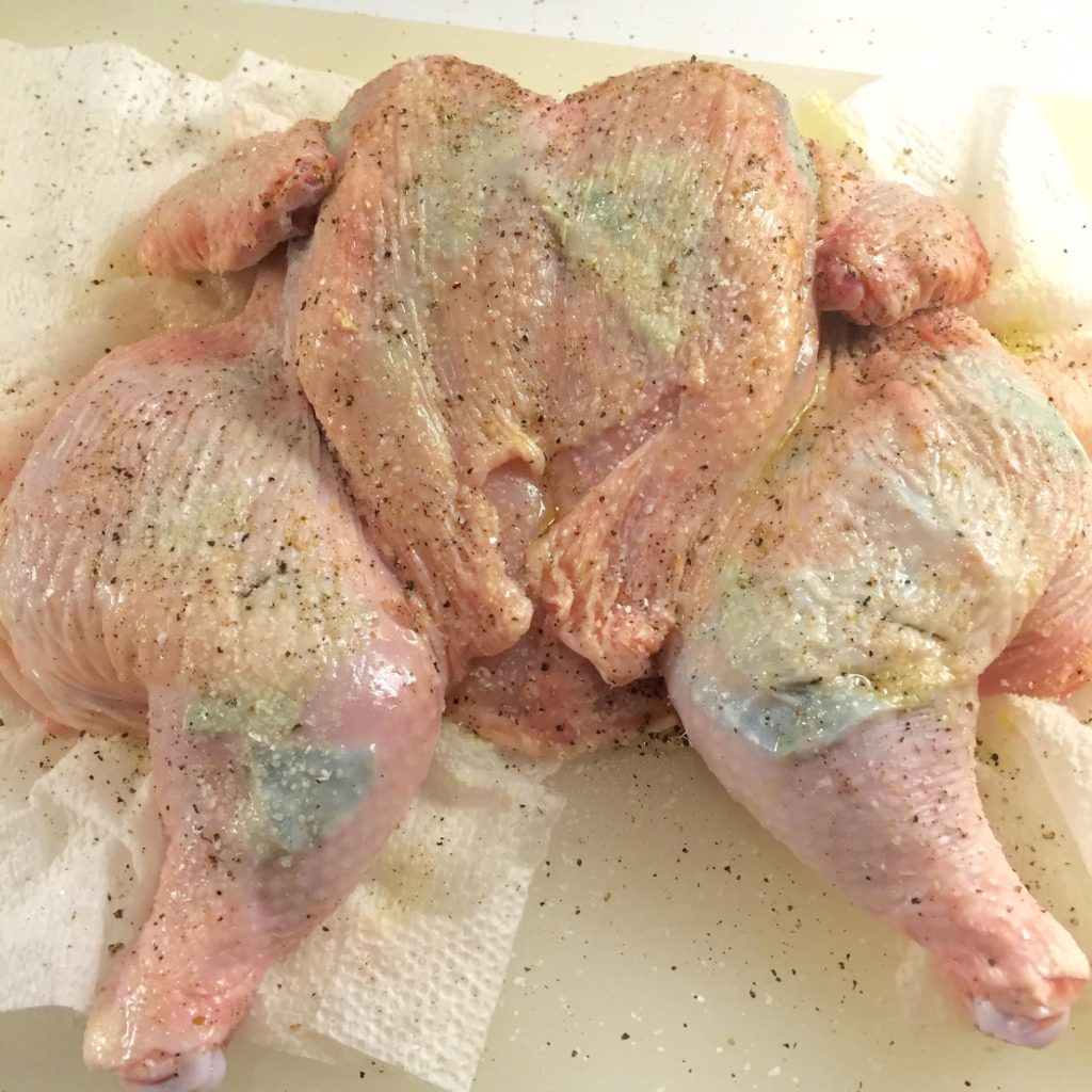 Raw chicken with fresh curry leaves underneath the skin.