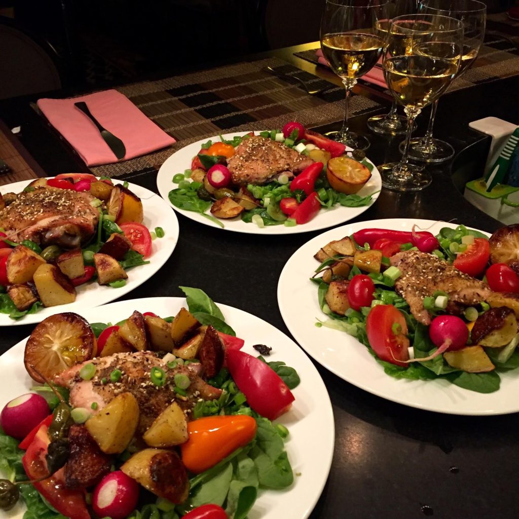 Four dinner salads with white wine.