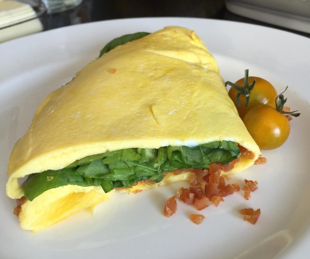 Chef’s Cut Honey Barbeque Chicken Jerky & Spinach Omelet finished on a white Wedgewood plate.