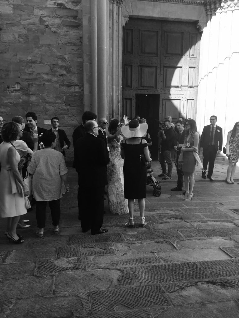 Guests waiting outside the church for the wedding to begin.