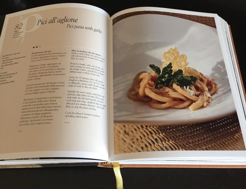 Tuscan cookbook open to Pici pasta recipe.