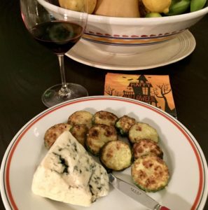 Zucchini slices breaded with finely ground Mom's Popped Lotus Seeds and Parmigiano cheese with a wedge of Roquefort cheese and a glass of red wine.