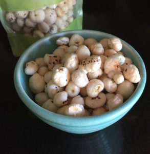 Mom's Popped Lotus Seeds sea salt flavor in a blue bowl.