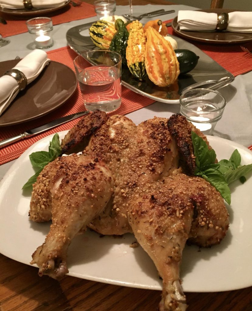 Quick nuts over fish mustard roasted chicken finished chicken on a white platter garnished with basil.