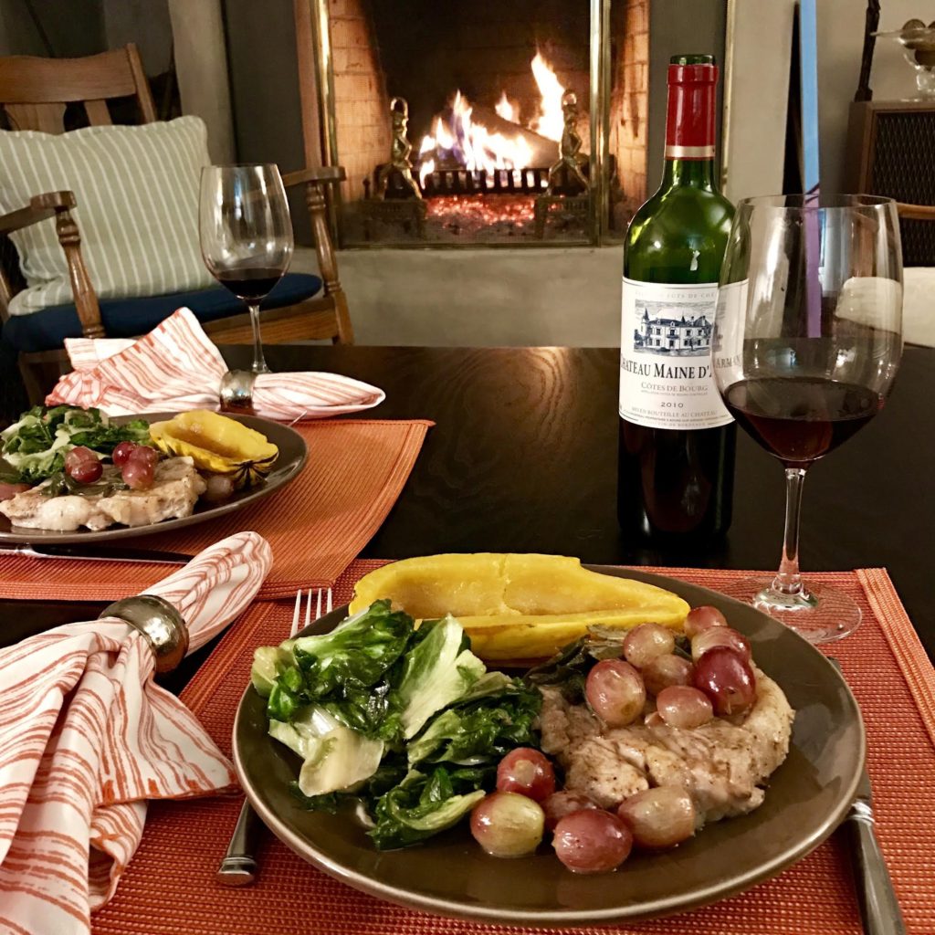 Braised Veal Chops with Honey and Red Grapes in front of a roaring fire.