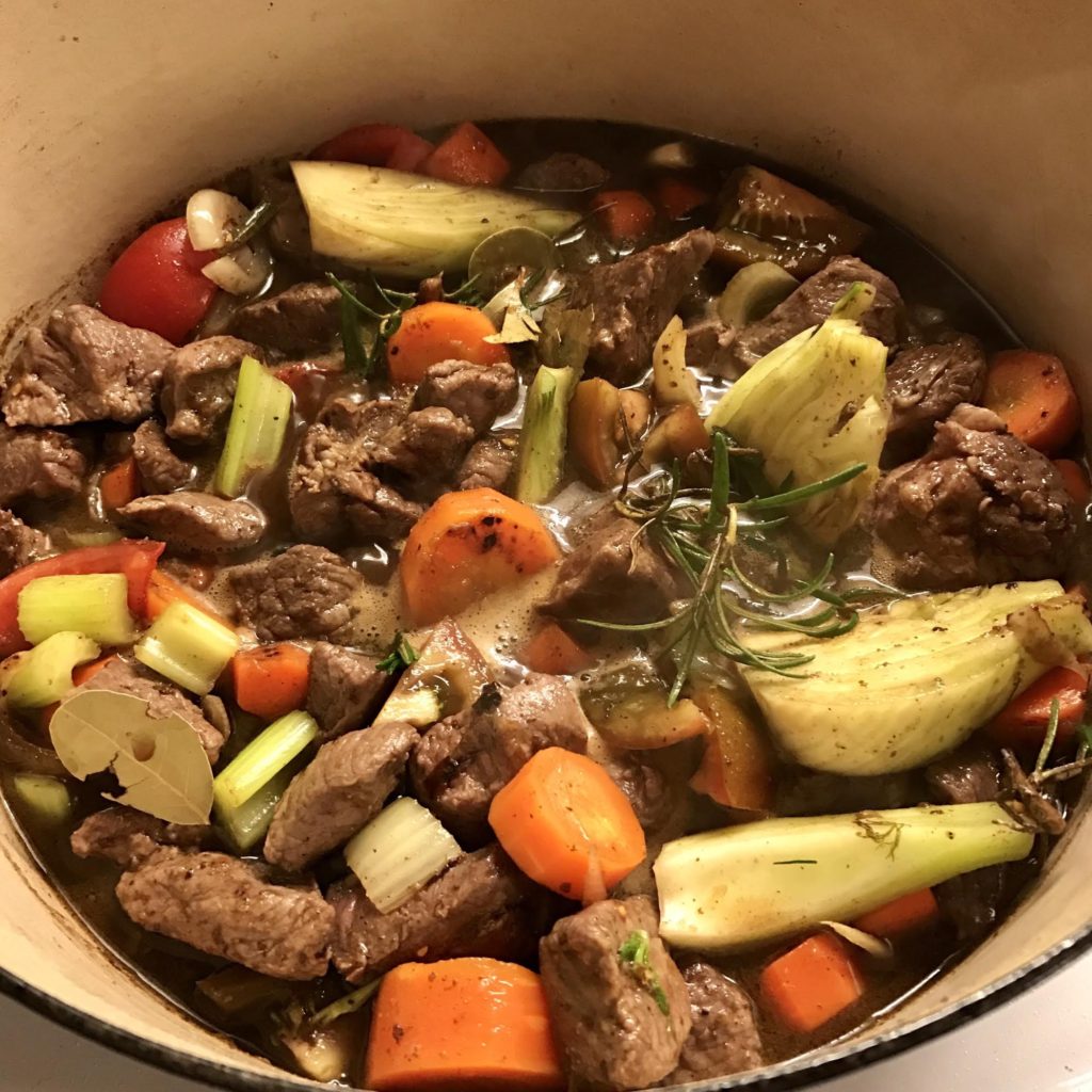 Lamb stew ready to roast in a Le Creuset pot.