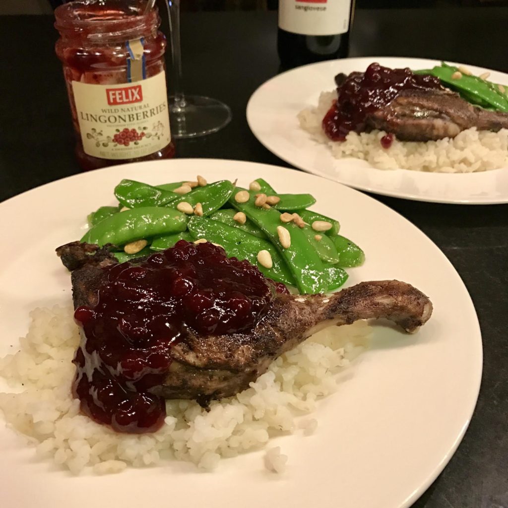 Felix Lingonberry jam on Chinese 5 Spice duck legs on a bed of rice on a white plate.