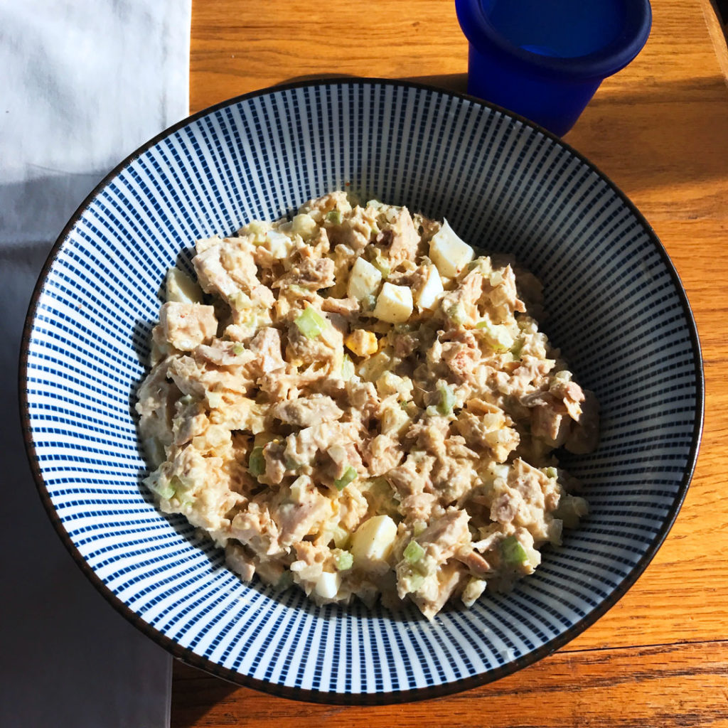 Tuna Salad Sandwiches with Holy Schmitt’s Mustard Horseradish in a blue and white bowl.