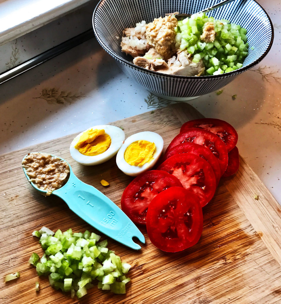 Holy Schmitt's horseradish tuna salad ingredients on a cutting