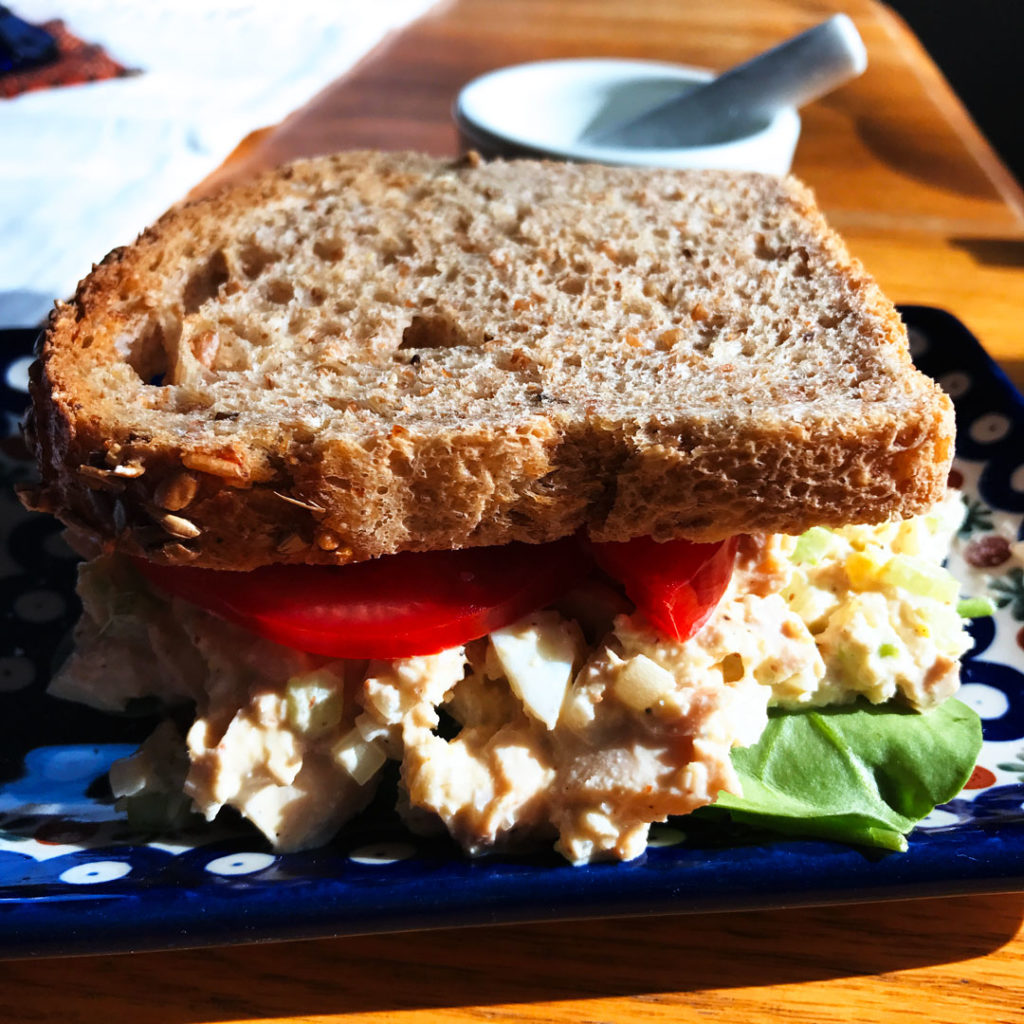 Whole Tuna Salad Sandwiches with Holy Schmitt’s Mustard Horseradish on a blue and white plate.