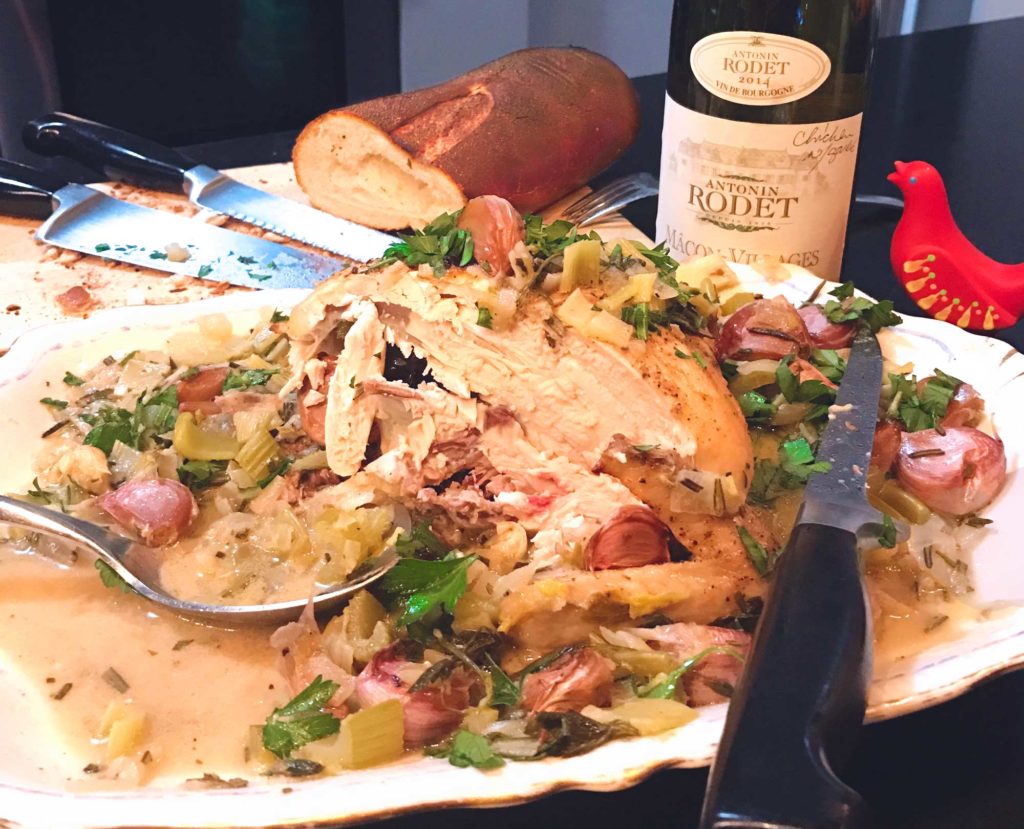 Joseph Joseph Smartbar with cut Chicken with 40 Cloves of Garlic, French bread and wine bottle.